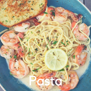 A plate of shrimp pasta with garlic bread