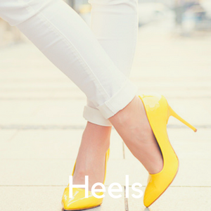 A woman in white jeans and yellow high heels