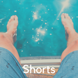 A man's legs in shorts above a pool