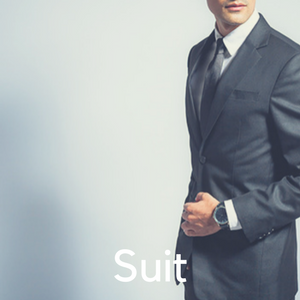 A man in a suit against a grey background