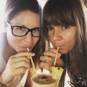Two women sip from a cocktail during happy hour at Margaritaville Caribbean.