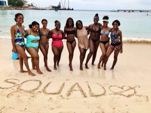 Women smile and pose for a photo on Negril's Seven Mile beach